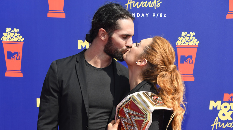 Becky Lynch and Seth Rollins kiss