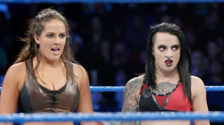 Sarah Logan and Ruby Riott standing inside the ring