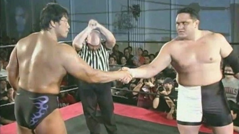 Kenta Kobashi shaking hands with Samoa Joe