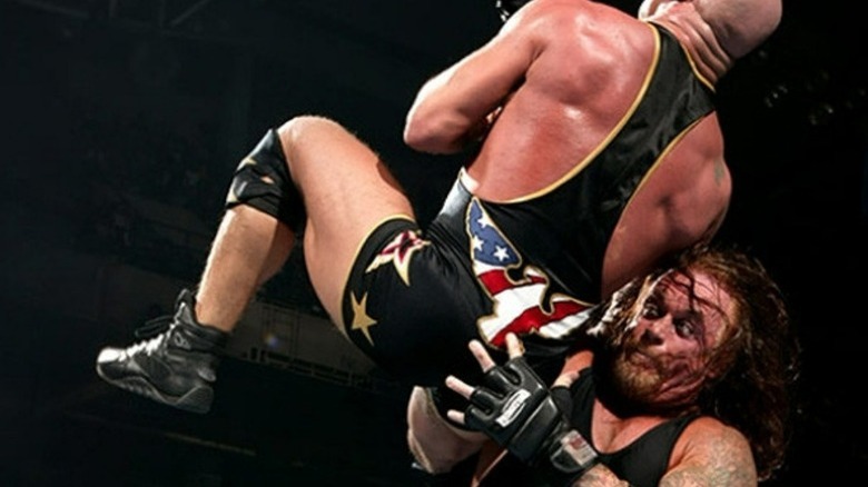 Undertaker chokeslamming Kurt Angle