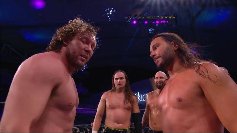 Kenny Omega and the Young Bucks in the ring