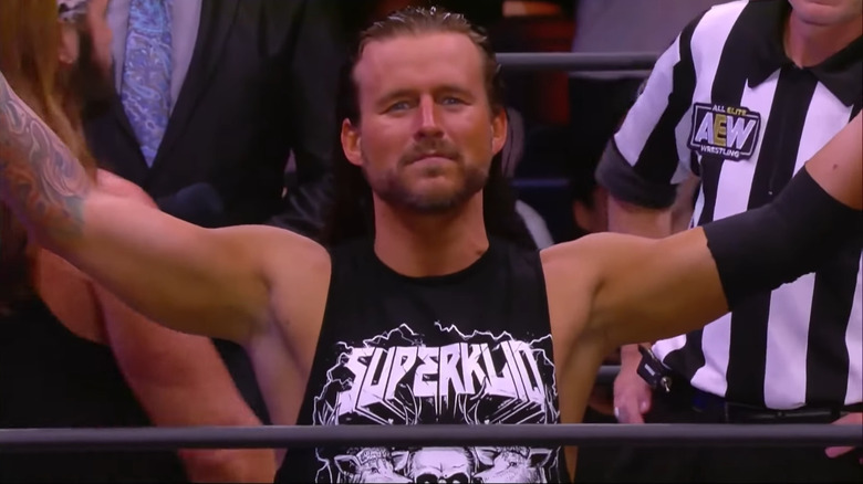 Adam Cole with his arms wide open