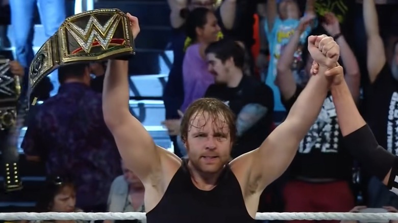 Dean Ambrose holding up the WWE title