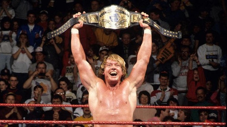 Roddy Piper hoists the WWE Intercontinental Championship