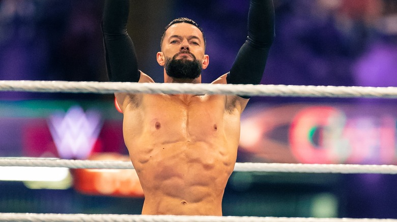 Finn Balor with his hands in the air