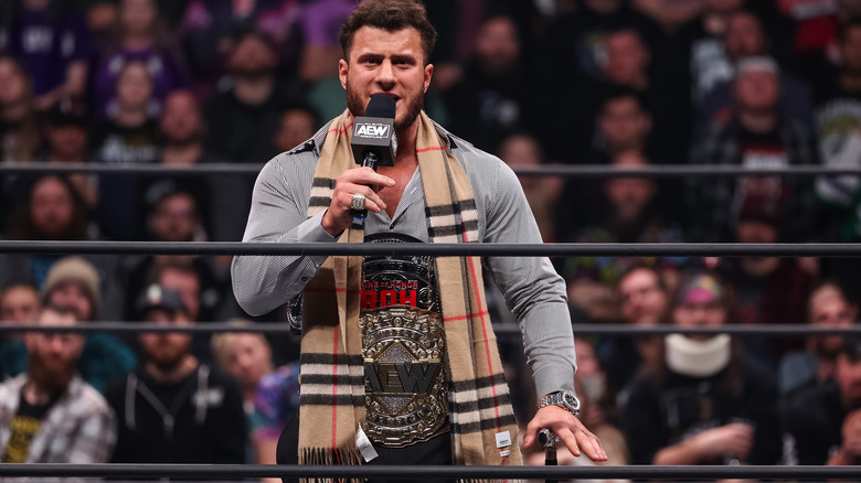 MJF with microphone, wearing title belts