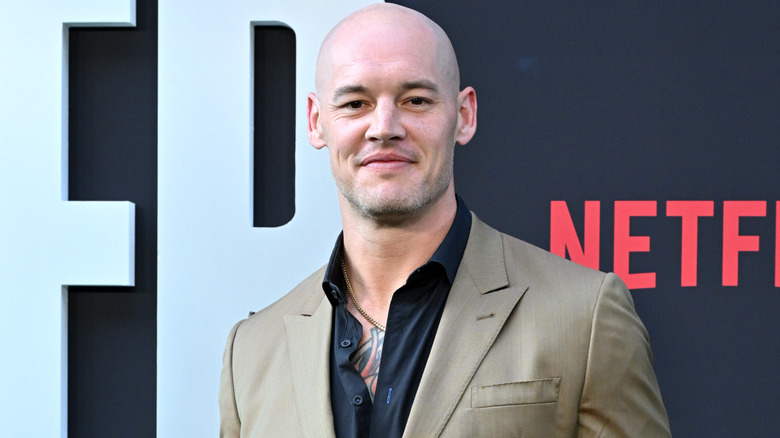 Baron Corbin wearing a beige suit jacket, with black shirt