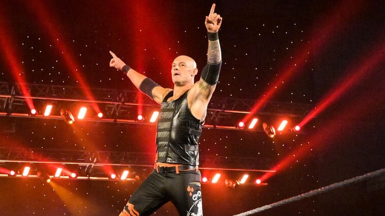 Tom Pestock, formerly known as WWE's Baron Corbin, points to the crowd after a victory in a WWE ring