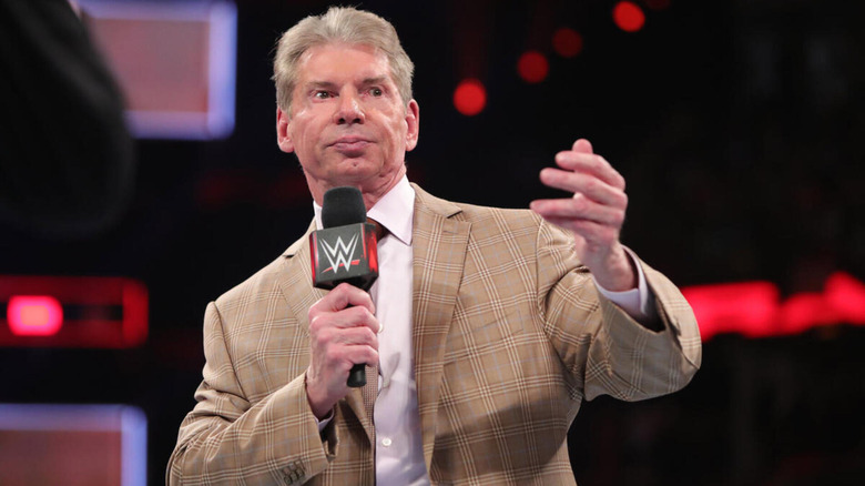 Vince McMahon speaks on the microphone.