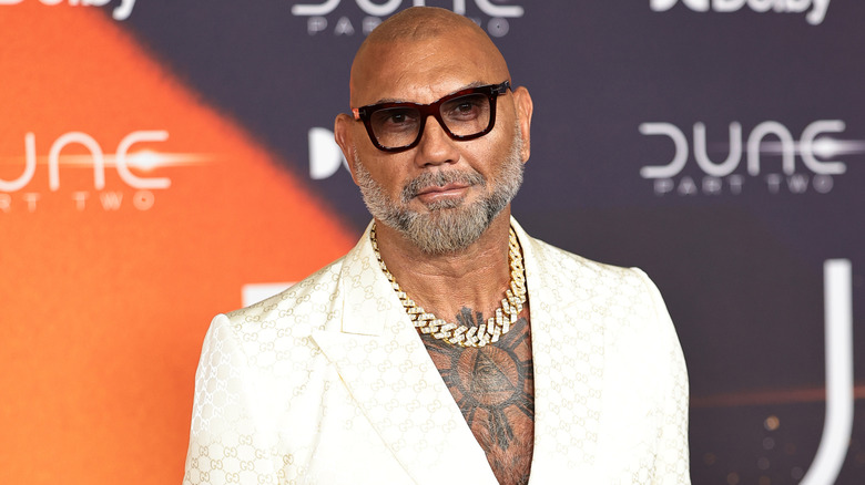 Dave Bautista wearing a white suit