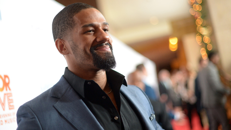 Fred Rosser smiles at a red carpet event