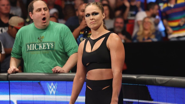 Ronda Rousey smirks during a match in WWE