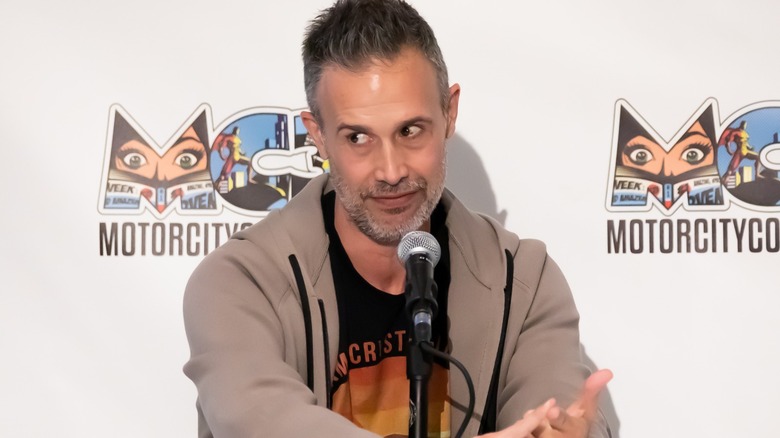 Freddie Prinze Jr. sitting a mic