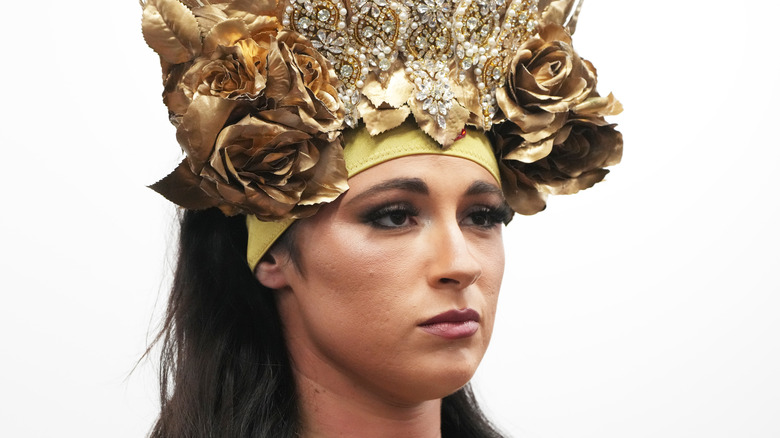 Close-up of Megan Bayne wearing elaborate flowery headgear