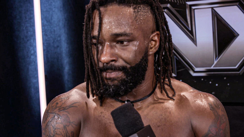 Cedric Alexander looks pensively off to the side mid-interview.