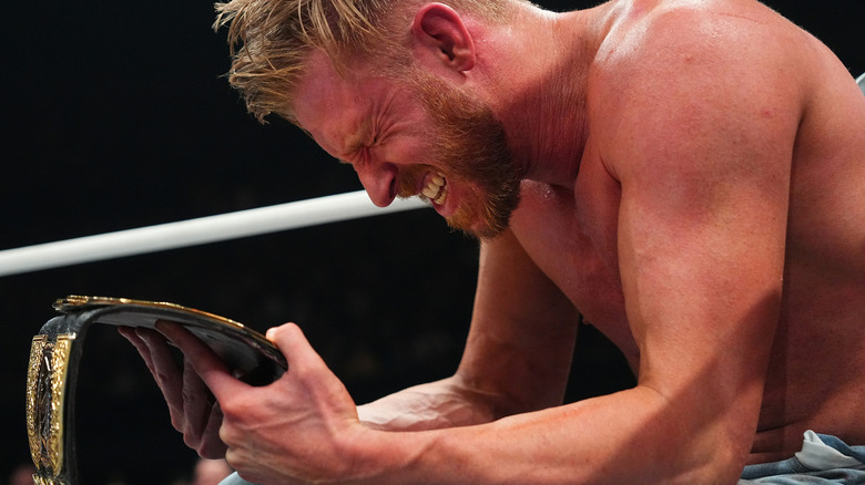 Orange Cassidy grimacing over his title belt