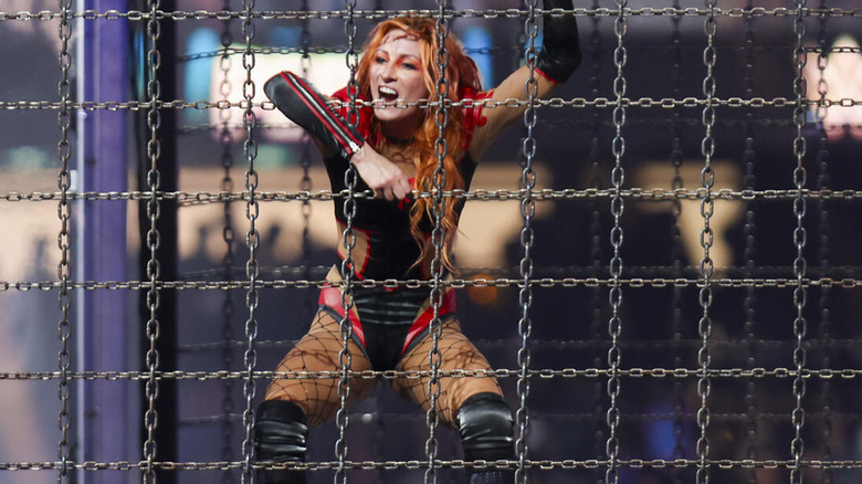 Becky Lynch climbing the side of the Elimination Chamber