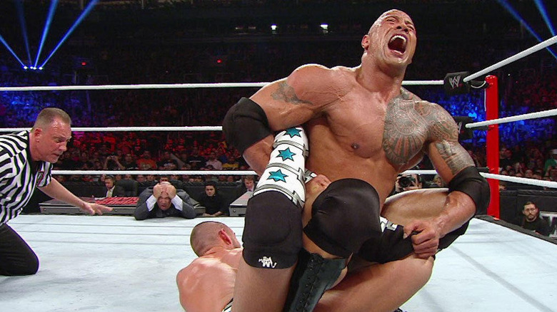 The Rock applying a submission to CM Punk