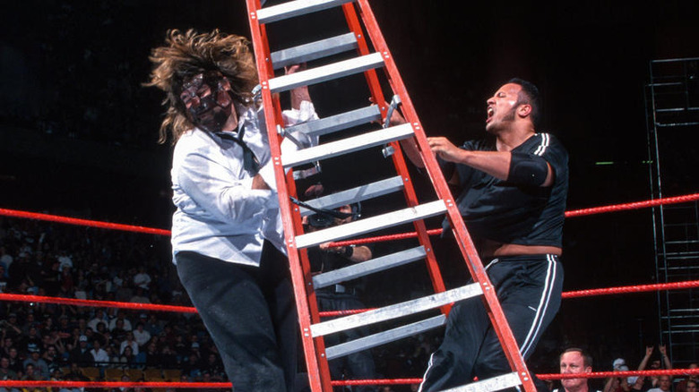 The Rock hitting Mankind with a ladder