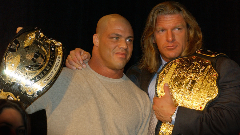 Kurt Angle and Triple H hold belts