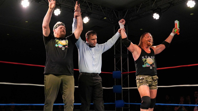 Shane Douglas and Brian Myers raise their arms