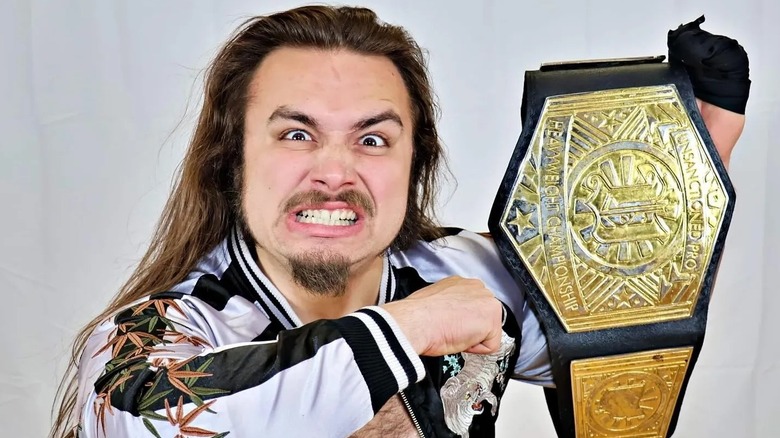 Independent wrestler star Charlie Tiger holds the Unsanctioned Pro Heavyweight Championship during a photoshoot