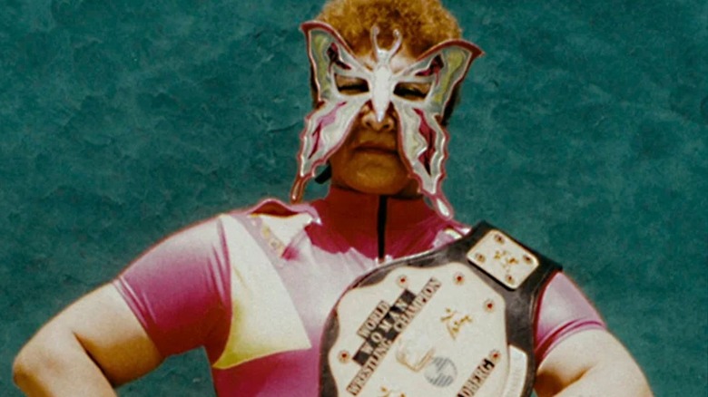 Juana Barraza Samperio is seen in a butterfly mask, posing with a championship, in an image seen on a Netflix documentary about her crimes.