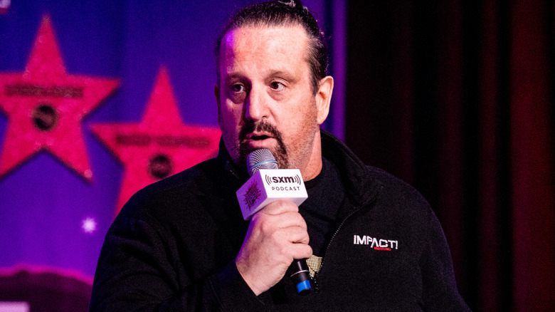 Tommy Dreamer talking into microphone