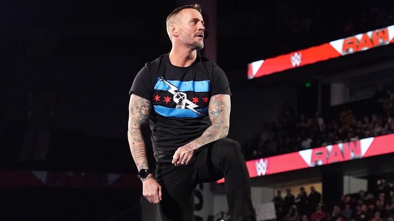 CM Punk perched on the top turnbuckle