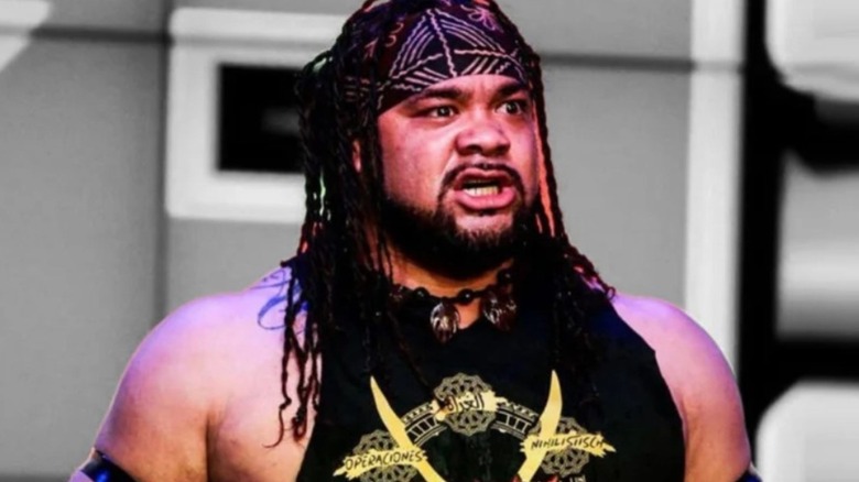 Jacob Fatu stands on the stage at a MLW show before a match.