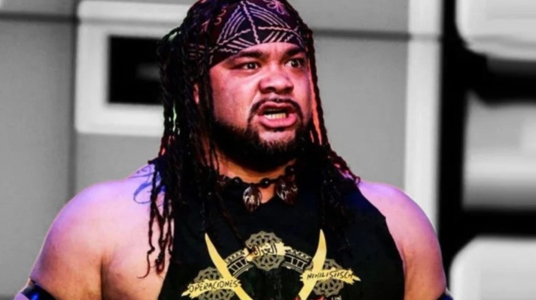 Jacob Fatu stands on the stage at a MLW show before a match.