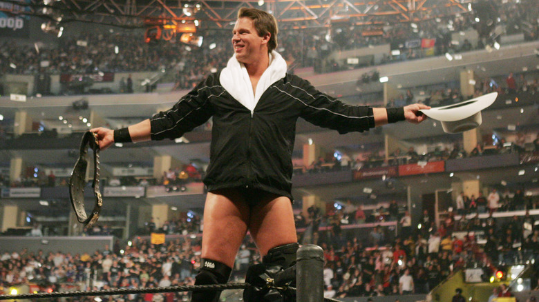 JBL posing in the ring holding his hat and the WWE Championship