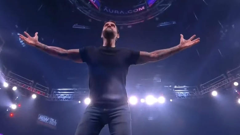 CM Punk stands with arms wide