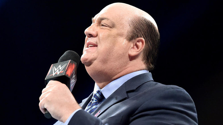 Paul Heyman speaking into a WWE microphone