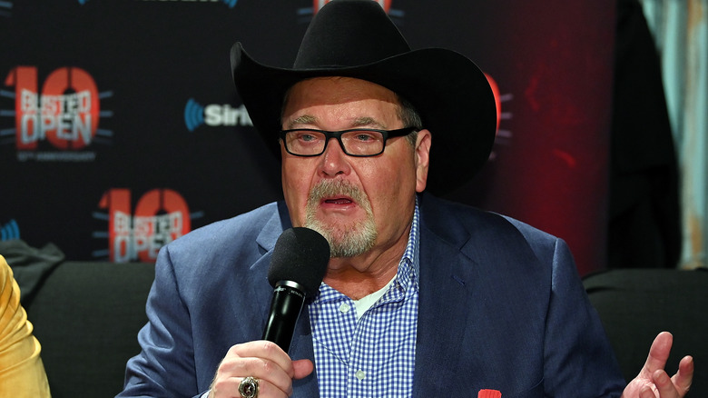 Jim Ross holding a mic