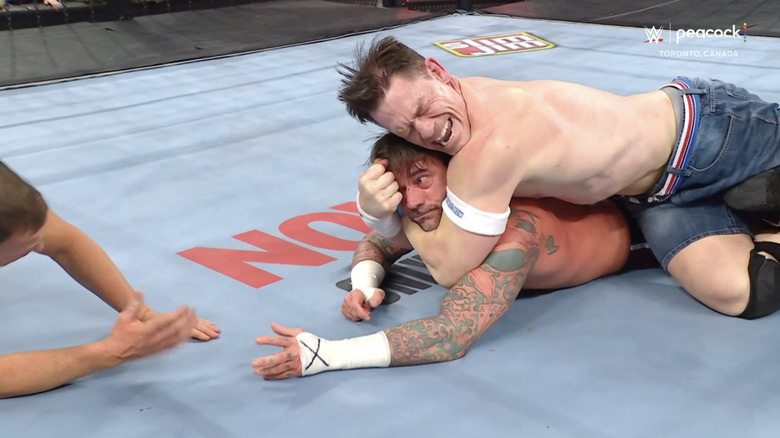 John Cena cinches in the STF on CM Punk.