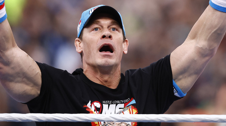 John Cena raises his arms