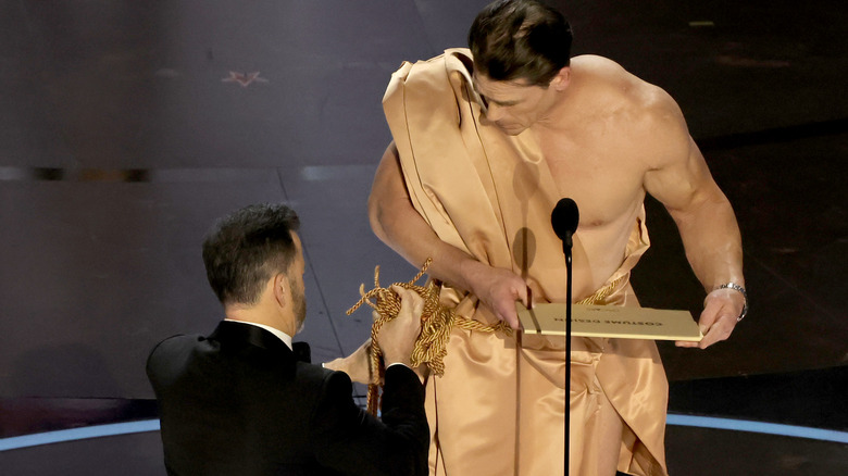 Jimmy Kimmel helping John Cena with his robe