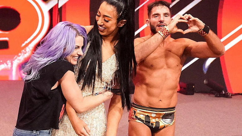 Johnny Gargano makes heart with his hands, stands with Candice LeRae and Indi Hartwell at "WWE NXT" Stand & Deliver 2023