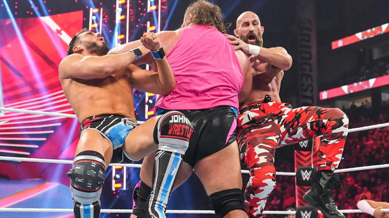 Johnny Gargano and Tommaso Ciampa are knocked over by Alpha Academy's Otis during a Number One Contenders Tag Team Turmoil Match on WWE Monday Night Raw.
