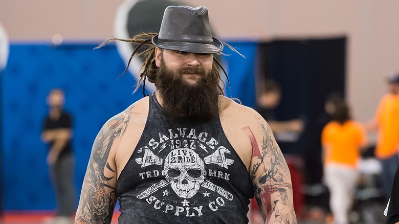 Bray Wyatt walking forward, hat nearly covering his eyes