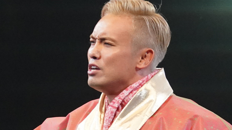 Okada striking his signature "rainmaker" pose