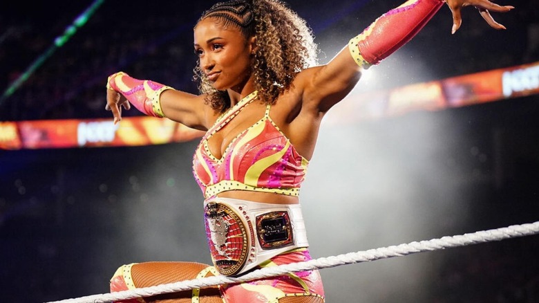 Kelani Jordan stands on the ropes and poses with her Women's North American Championship ahead of a match on "WWE NXT."