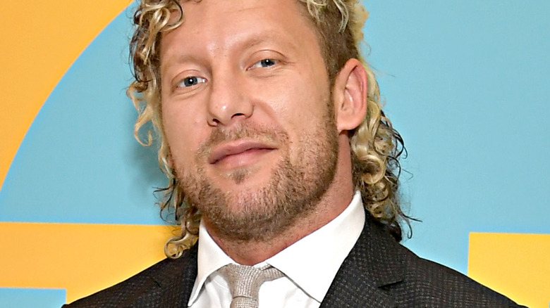 Kenny Omega smiles at a promotional event 