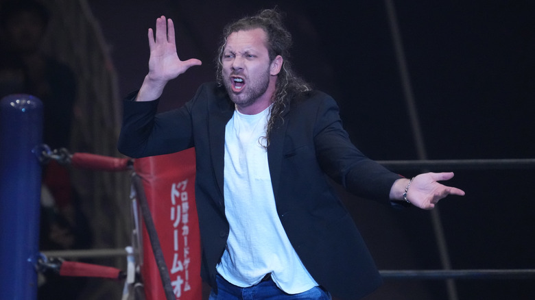 Kenny Omega poses in the ring during NJPW return