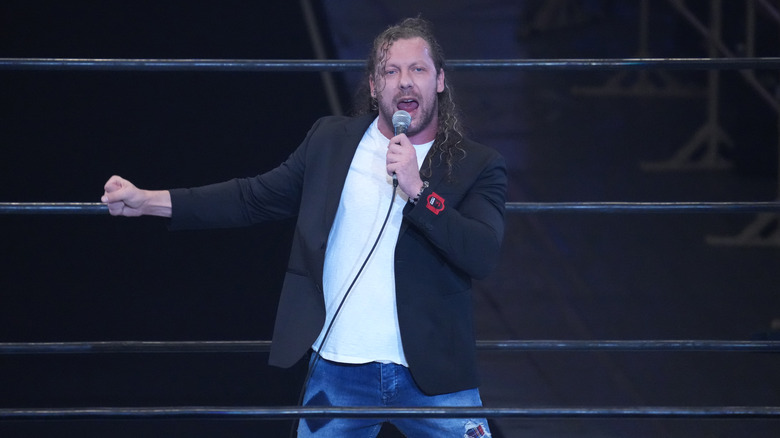 Kenny Omega talking into a microphone during his return to NJPW