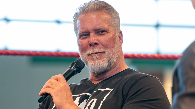 Kevin Nash holding a microphone