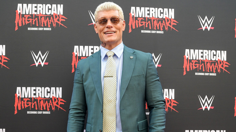 Cody Rhodes smiling in a suit