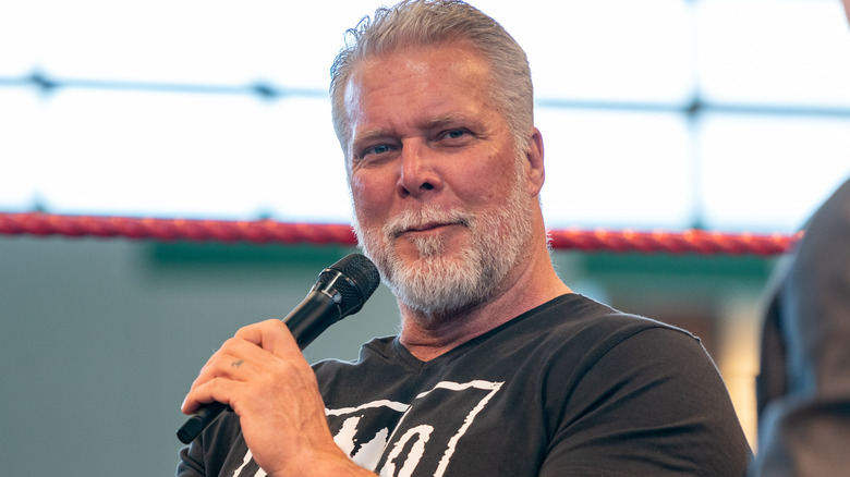 Kevin Nash holding a microphone