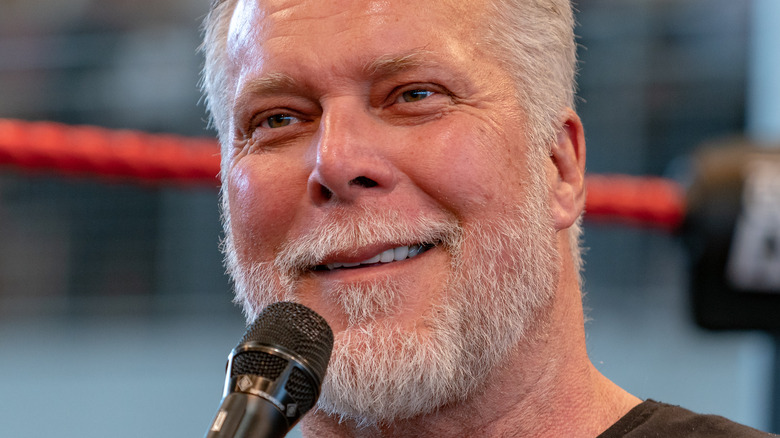 Kevin Nash smiling with a microphone